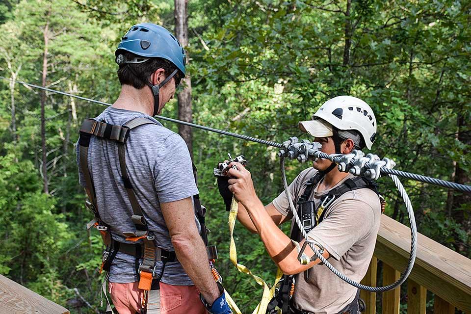 Safety is always first when attaching to the zip line.